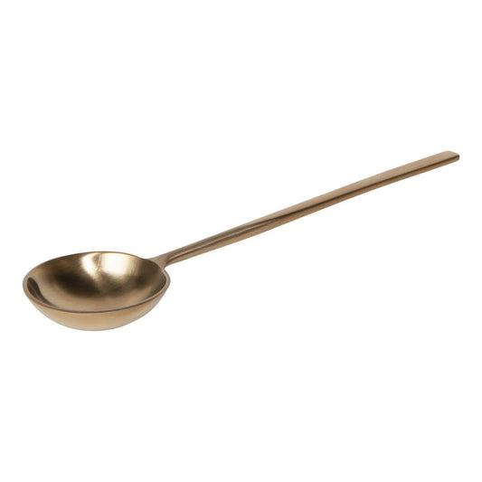 A long-handled gold-coloured spoon, shown diagonally on a plain white background.