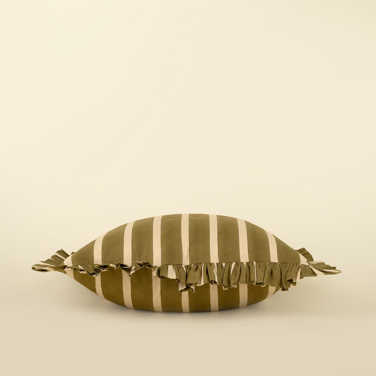 An olive green and cream striped decorative throw pillow with a fringed edge, photographed against a solid cream background.