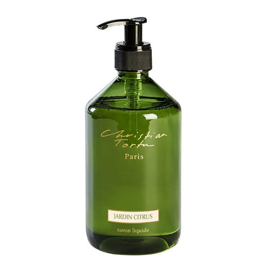 Christian Tortu's Jardin Citrus green glass liquid soap dispenser with a black pump and gold lettering, on a white background.