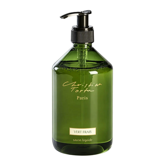 Christian Tortu's Vert Frais green glass liquid soap dispenser with a black pump and gold lettering, on a white background.