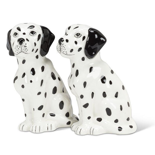 A pair of ceramic Dalmatian salt and pepper shakers sitting side-by-side on a white background.