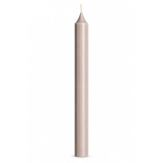 A single tall, slender pale warm grey taper candle with a white wick, centered against a solid white background.
