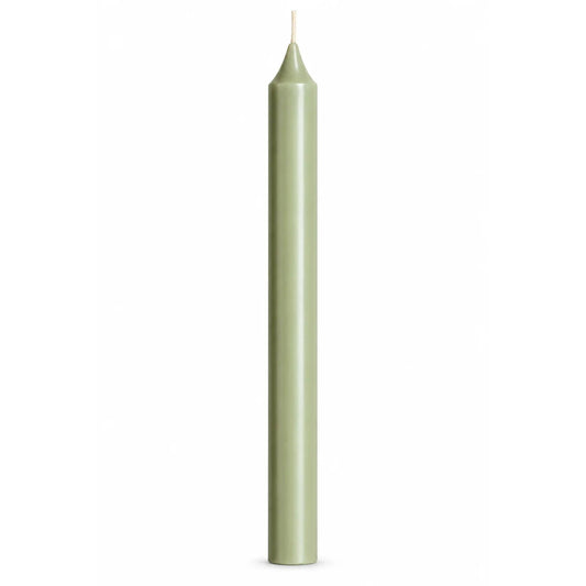 A single tall, slender pale green taper candle with a white wick, centered against a solid white background.