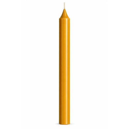 A single tall, slender yellow ochre taper candle with a white wick, centered against a solid white background.