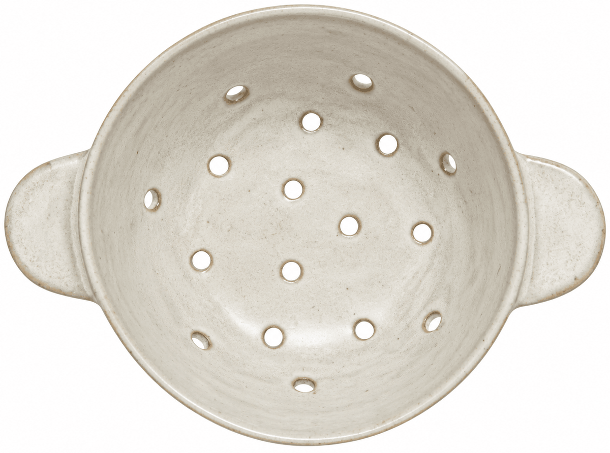 An off-white ceramic colander with side handles and multiple drainage holes, shown from a top-down view on a white background.