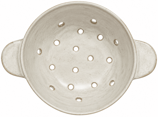 An off-white ceramic colander with side handles and multiple drainage holes, shown from a top-down view on a white background.
