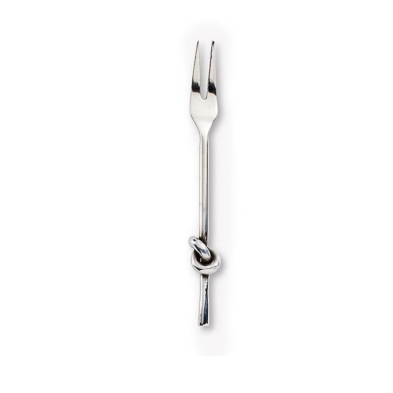 Chrome cocktail fork with knot detail on the handle, set on white background.