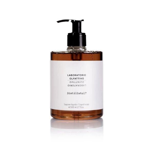 Distillato7 Laboratorio Olfattivo hand soap in a clear amber bottle with a white label and black pump dispenser, shown on a white background with a reflection.