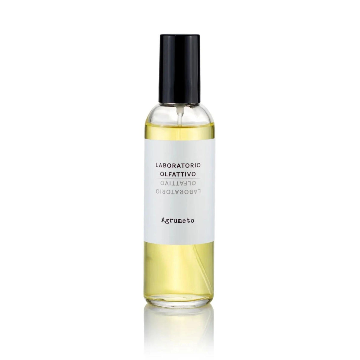 A clear glass spray bottle filled with pale yellow liquid, featuring a white label with black text and a black spray cap, centered on a white background with a soft reflection below.