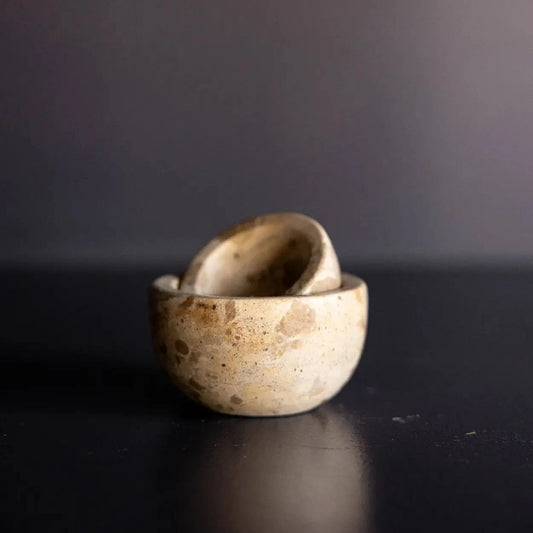 Brown and beige marble pinch bowls on dark background.