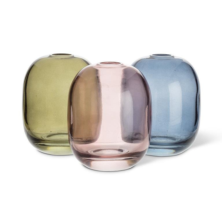 Three glass vases in green, pink, and blue on a white background.