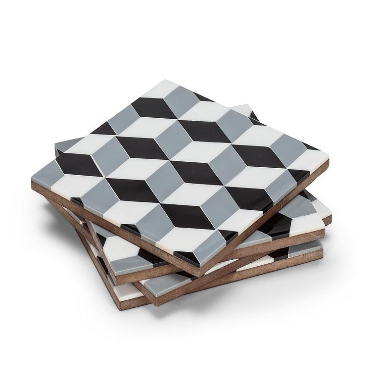 Four square coasters stacked at an angle, featuring a 3D optical illusion geometric pattern in black, white, and gray, with a natural wood edge visible on the side.