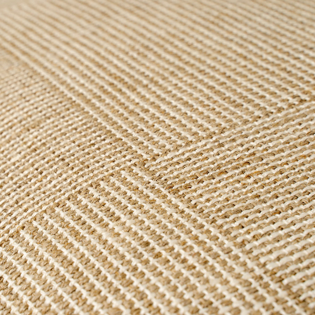 A close-up of woven fabric texture in a warm tan and cream checkerboard pattern.