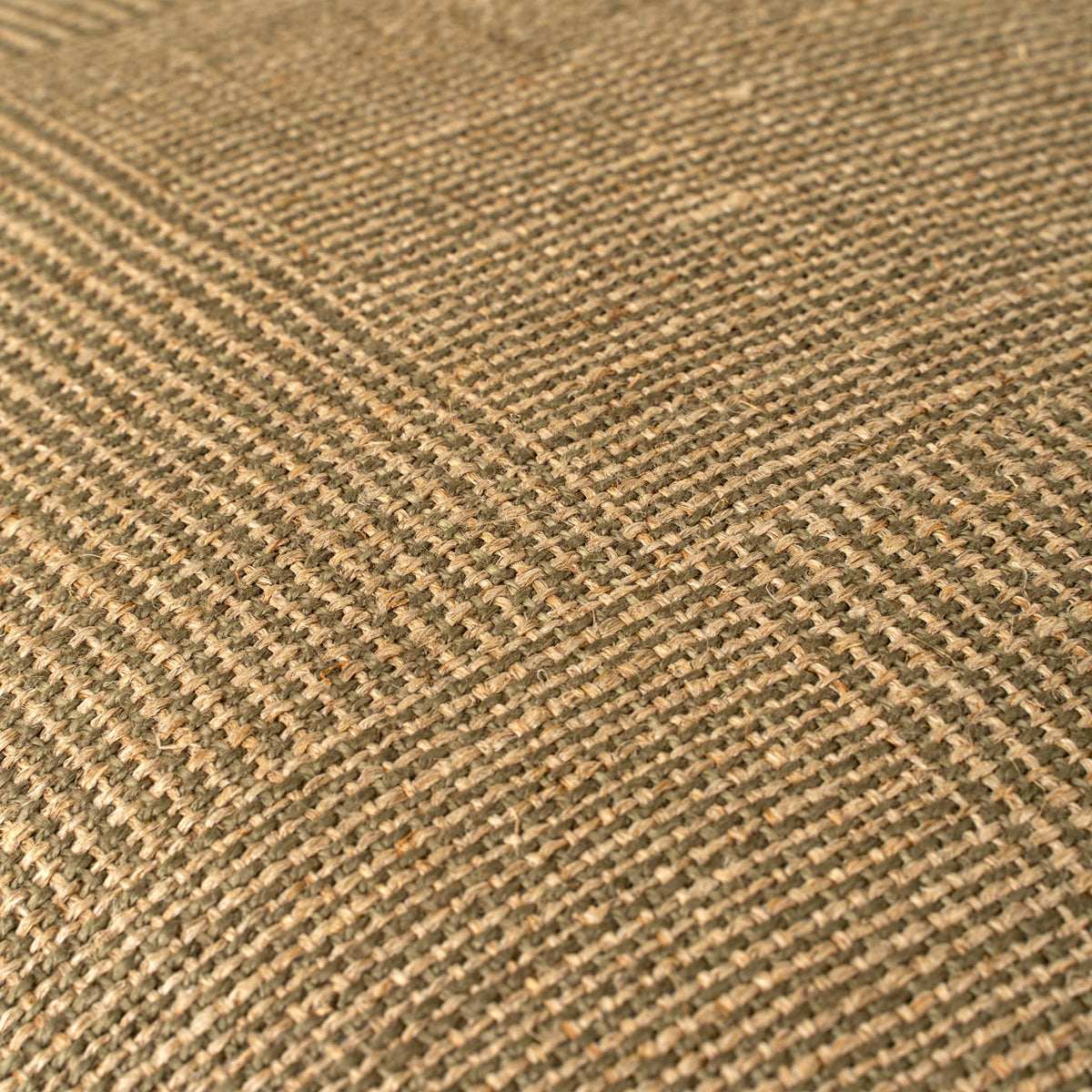 A close-up of woven fabric texture in a warm tan and olive checkerboard pattern.