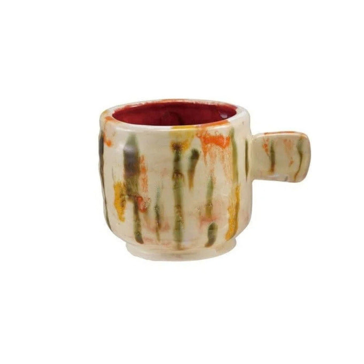 A small ceramic mug with a handle, featuring a cream-colored exterior with vertical green, orange, and yellow paint-stroke patterns, and a deep red glazed interior, shown against a plain white background.