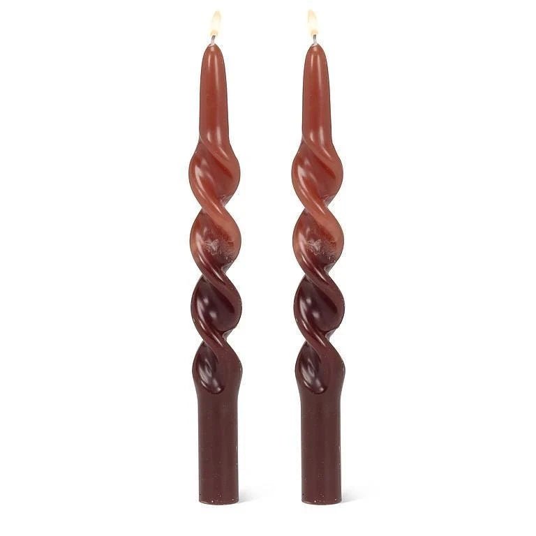 Two dark brown twisted taper candles with a flared base, shown standing upright on a plain white background.